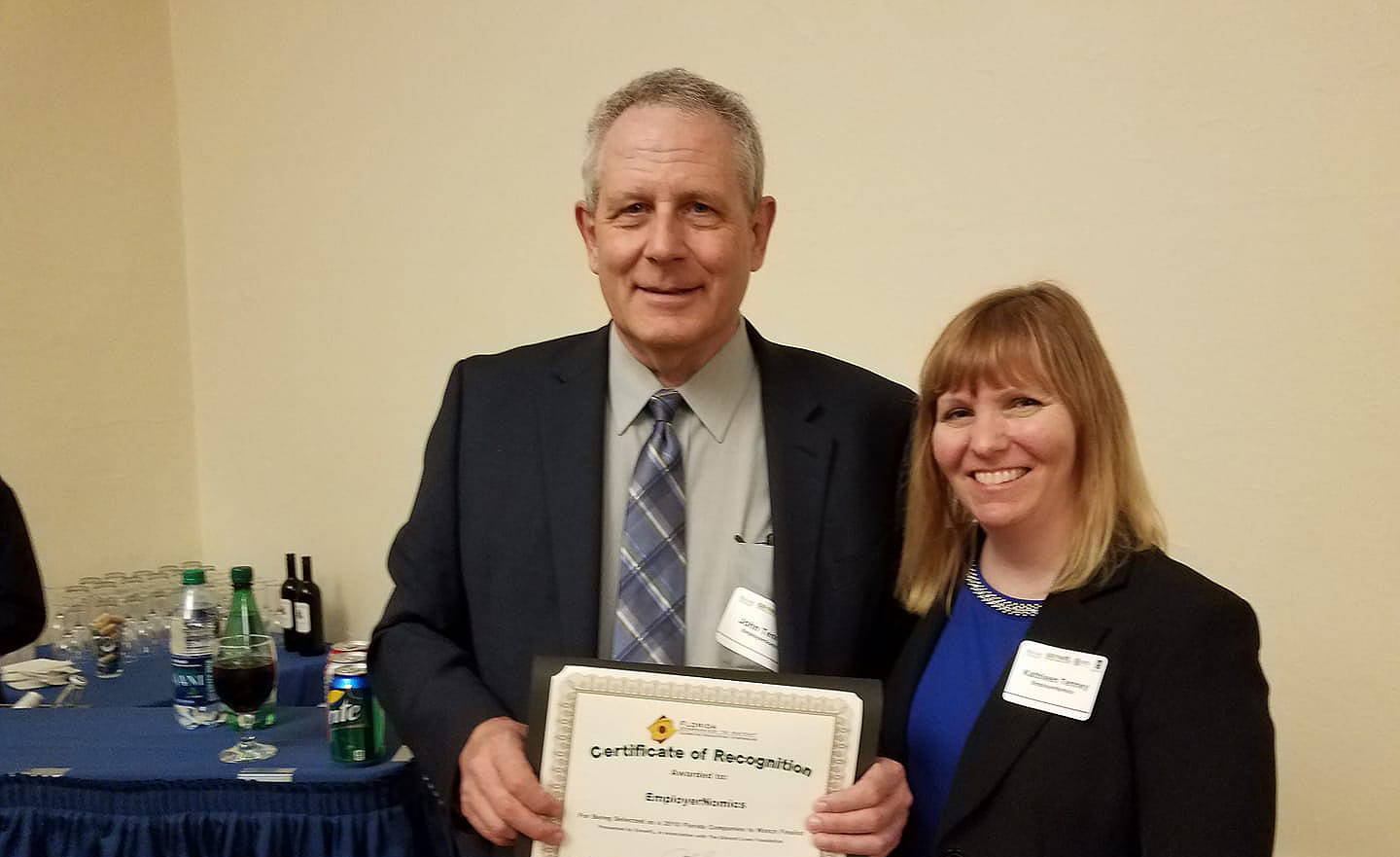 John and Kathleen Tenney representing EmployerNomics, receiving the finalist certificate from GrowFL